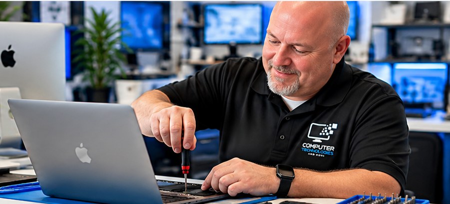 Technician servicing a computer at a Mac repair workstation